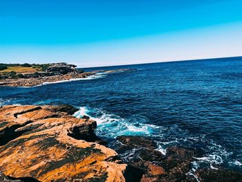 Scenic view of sea against clear blue sky