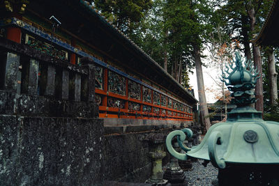 Low angle view of old building by trees