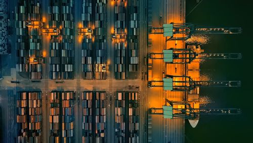 Top view of container ship yards pier at night