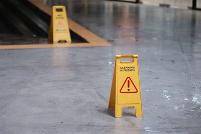 Yellow sign of caution reserve cleaning on the wet floor