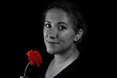 Portrait of beautiful woman against black background