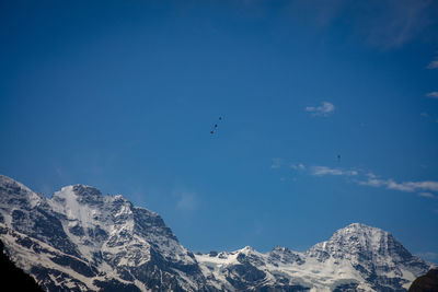 Low angle view of skydiver and mountains in the sky over lauterbrunnen valley.