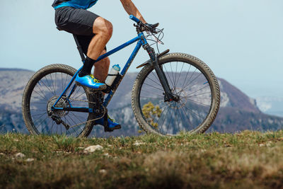 Low section of man riding bicycle