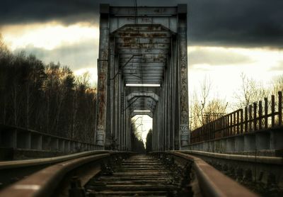 Railroad tracks amidst trees against sky