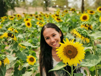 Portrait of smiling woman with sunflower