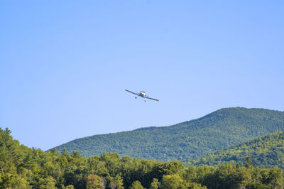 Low angle view of airplane flying in sky