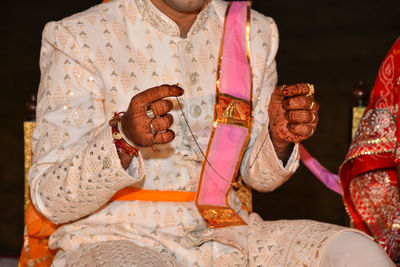 Close-up of hands on cross