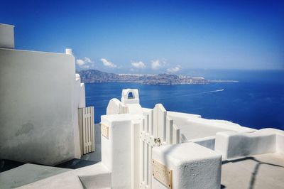 Whitewashed buildings in santorini by sea