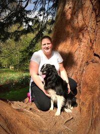 Portrait of a smiling young woman with dog