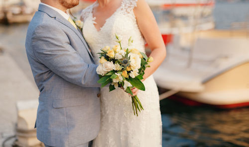 Midsection of woman holding flower bouquet