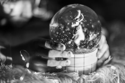 Holding a snow globe 