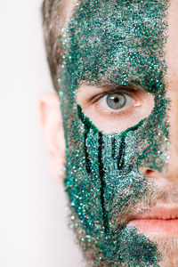 Close-up portrait of man with glitter