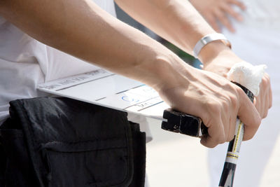 Close-up of man holding clapper board