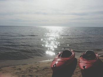 Kayaks moored on sunny beach