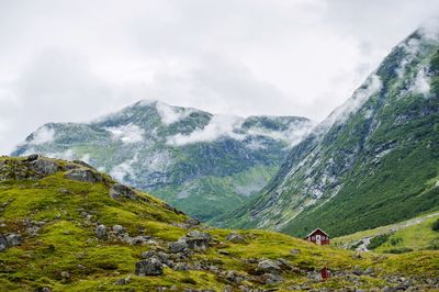 Scenic view of mountains against cloudy sky