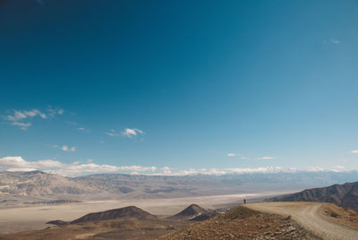 Scenic view of desert against blue sky