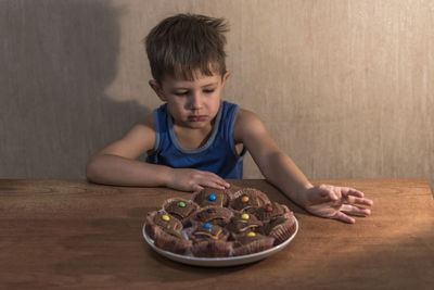 Portrait of boy with sunglasses on table