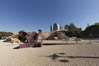 View of park against clear blue sky