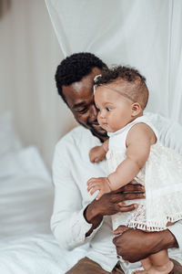 Mother with baby on bed