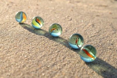 Close-up of multi colored stones on sand