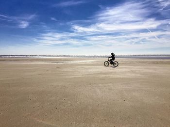 Woman riding bicycle on road