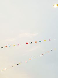 Low angle view of colorful buntings hanging against sky