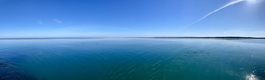 Scenic view of sea against blue sky