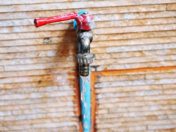 Close-up of faucet against wall