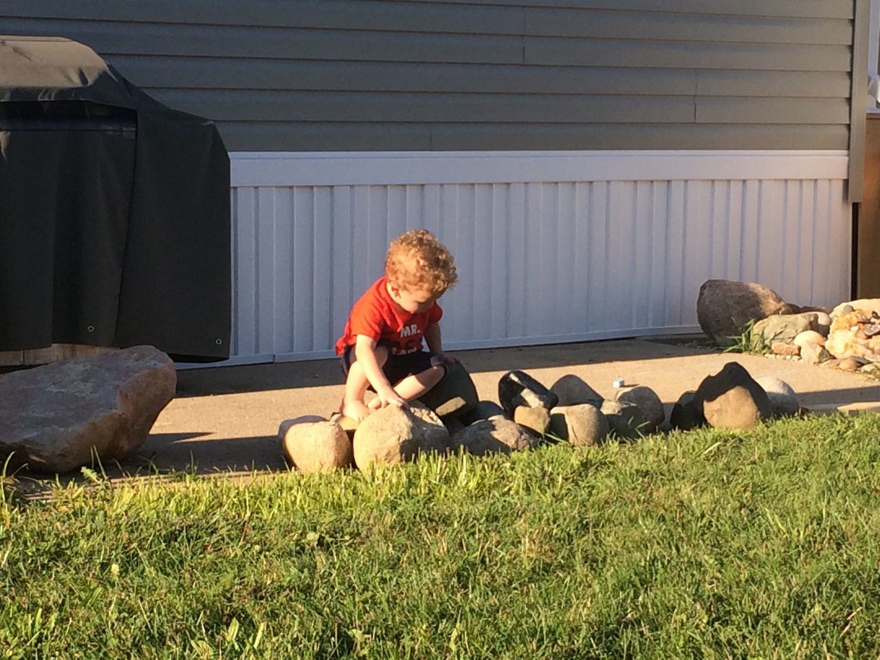 SIDE VIEW OF A GIRL HOLDING GRASS