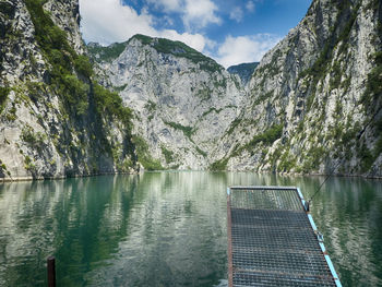 Scenic view of lake and mountains against sky