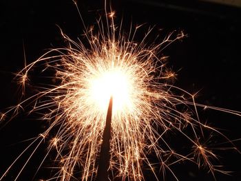 Low angle view of firework display at night