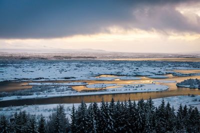 Scenic view of lake against sky during winter