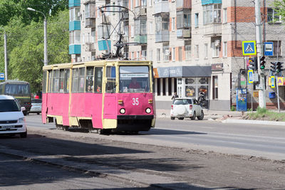 Old red yellow tram on a street in russia