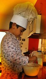 Portrait of boy holding ice cream at home