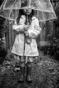 Full length of woman standing in rain