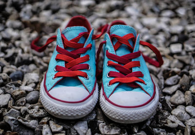 Close-up of baby boots on stones