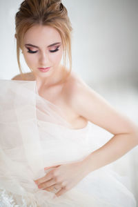 Young bride against white background