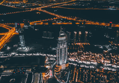 High angle view of illuminated cityscape against sky at night