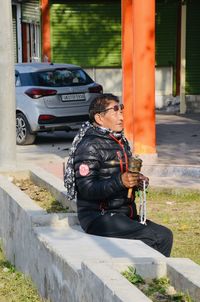 Man holding camera while sitting in car