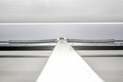 Guiding rails for a home garage door and steel rope drums, view from above.