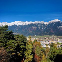 Scenic view of tree mountains against blue sky