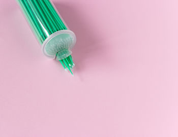 High angle view of electric lamp against pink background