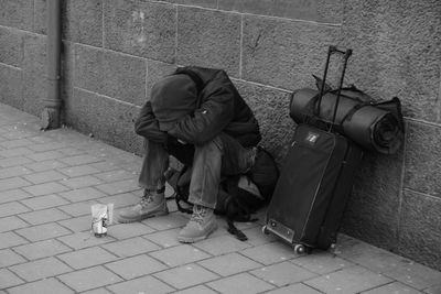 Man sitting on sidewalk