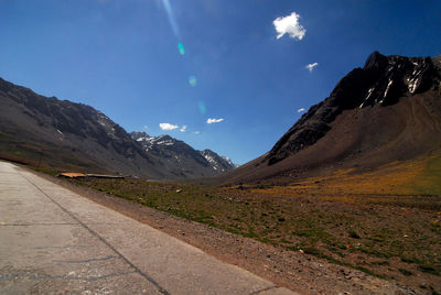 Scenic view of snowcapped mountains against blue sky