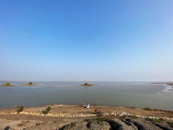 Scenic view of sea against clear blue sky