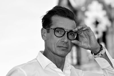 Portrait of man wearing eyeglasses standing outdoors