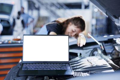 Businesswoman using laptop at office