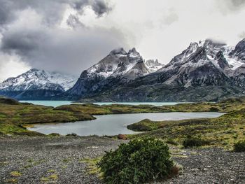 Scenic view of lake and mountains against sky