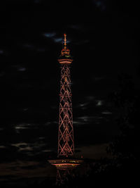 Low angle view of illuminated tower against sky at night