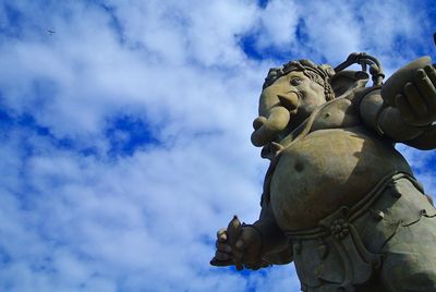 Low angle view of statue against sky